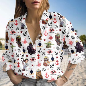 May include: White button-down shirt with a Star Wars and Disney Cruise Line pattern. The shirt features various Star Wars characters, anchors, compasses, and the Disney Cruise Line logo. The long-sleeved shirt has a collared neckline.