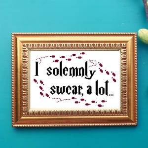 May include: A framed cross-stitch design with a white background and burgundy red stitching. The design features a quote from the Harry Potter series: "I solemnly swear, a lot..." with a trail of footprints around the text.