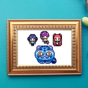 May include: A framed pixel art piece featuring a blue cat and three anime-style characters. The artwork is in a gold-colored frame, set against a teal background. The cat has large yellow eyes and a smiling mouth.