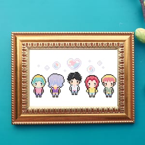 May include: A framed pixel art print featuring five anime-style characters with different hair colors and outfits. The artwork includes pixelated bubbles and a heart shape. The frame is gold-colored and has a detailed, ornate design.
