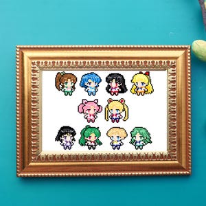 May include: A framed cross-stitch featuring pixel art of the Sailor Moon characters. The characters are in their school uniforms and are arranged in a grid pattern.