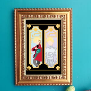 May include: A framed pixel art print featuring two figures with blonde hair. One figure wears a red coat and holds a staff, the other wears a silver outfit. The artwork is framed in a gold, ornate frame.