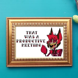 May include: A framed cross-stitch design featuring a cartoon character with red horns and a red suit. The text "THAT WAS A PRODUCTIVE MEETING" is written in white letters.