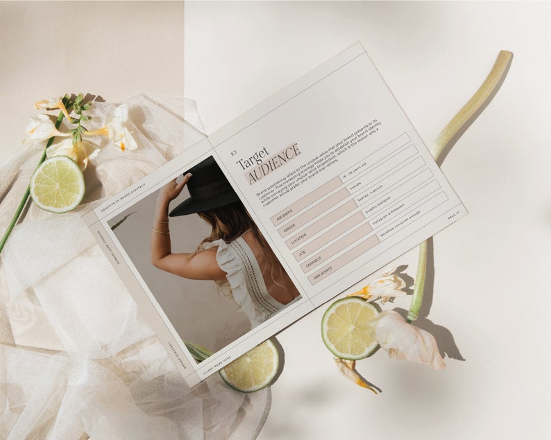 May include: A worksheet with the title "Target Audience" and a list of questions to help define your target audience. The worksheet is on a white surface with a floral arrangement and lemons.