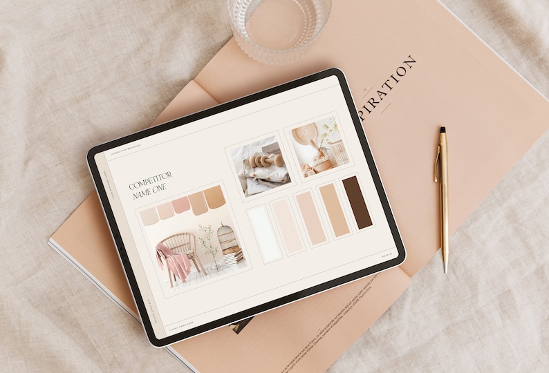 May include: A tablet screen displaying a competitor's color palette and design inspiration. The screen shows a color palette with shades of brown, beige, and white. The tablet is on top of a magazine with the word "Inspiration" printed on the cover.