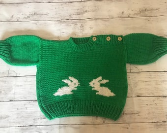 Maglione per bebè lavorato a mano verde giada con dettaglio di coniglio.