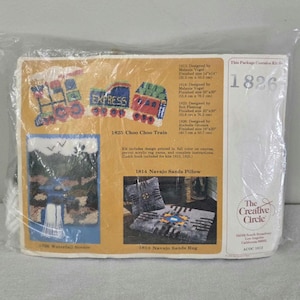 May include: A package containing a craft kit for making a rug depicting a train. The kit includes pre-printed canvas, acrylic rug yarn, and instructions. The package also includes the text "1825 Choo Choo Train" and "This Package Contains Kit No. 1826".