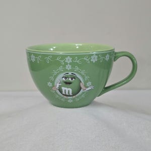 M&M&#39;s World Jumbo Green Ceramic Mug With White Floral Design Made In Thailand