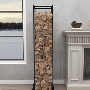 May include: Black metal log rack with stacked firewood inside. The rack is standing on a wood floor in front of a white fireplace.