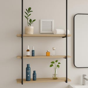 May include: A three-tiered wooden shelf unit with black metal supports, holding various bathroom products and decorative items. The shelves display skincare bottles, a small plant, a rolled towel, and a decorative square. The unit is mounted against a neutral wall.