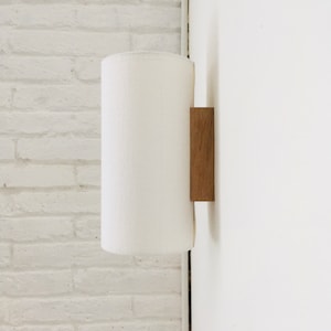 Vägglampa tillverkad av ekträ och vitt linnetyg. Vägglampa för hembelysning och dekoration i japansk stil.