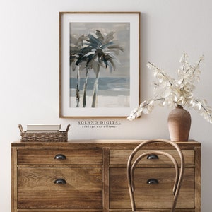 Printable wall art featuring abstract brushstrokes of palm trees with an ocean backdrop, available for digital download on Etsy. Ideal for adding a serene coastal vibe to any room, perfect for beach lovers and modern art enthusiasts.