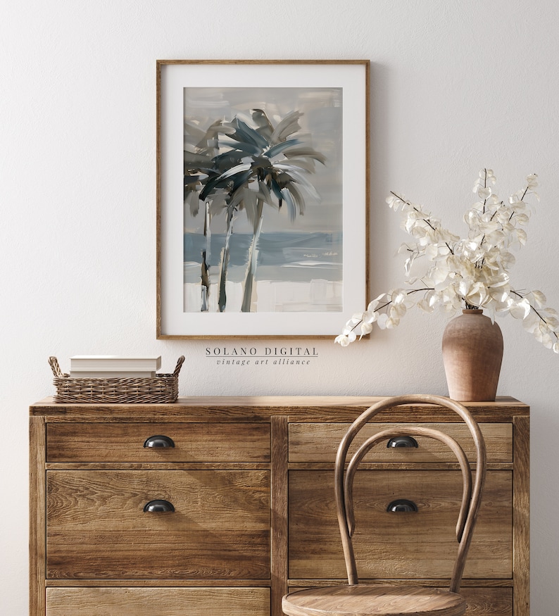 Printable wall art featuring abstract brushstrokes of palm trees with an ocean backdrop, available for digital download on Etsy. Ideal for adding a serene coastal vibe to any room, perfect for beach lovers and modern art enthusiasts.