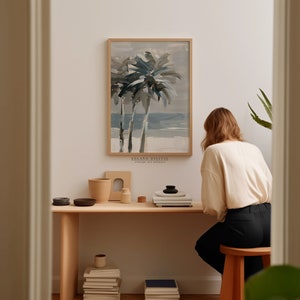 Printable wall art featuring abstract brushstrokes of palm trees with an ocean backdrop, available for digital download on Etsy. Ideal for adding a serene coastal vibe to any room, perfect for beach lovers and modern art enthusiasts.