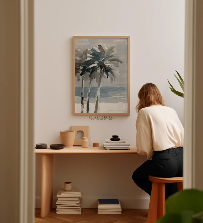Printable wall art featuring abstract brushstrokes of palm trees with an ocean backdrop, available for digital download on Etsy. Ideal for adding a serene coastal vibe to any room, perfect for beach lovers and modern art enthusiasts.