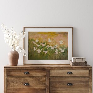 Charming painting of white geese in a vibrant meadow, perfect for nursery or cottagecore decor. Available as a printable digital download on Etsy, this abstract vintage artwork adds a whimsical touch to any farmhouse or vintage-themed space.