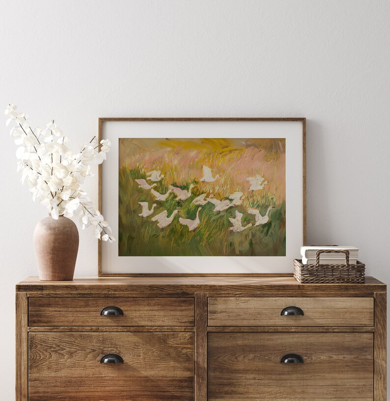 Charming painting of white geese in a vibrant meadow, perfect for nursery or cottagecore decor. Available as a printable digital download on Etsy, this abstract vintage artwork adds a whimsical touch to any farmhouse or vintage-themed space.