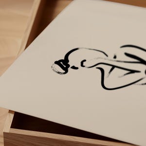Modern boho contour drawing of a woman seated; printable artwork available on Etsy; complements bathroom or vanity spaces.