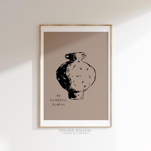 May include: A framed art print featuring a black and white illustration of a vase on a tan background. The text "BE AUTHENTIC, ALWAYS" is below the vase. The bottom of the print includes the text "SOLANO DIGITAL vintage art alliance."