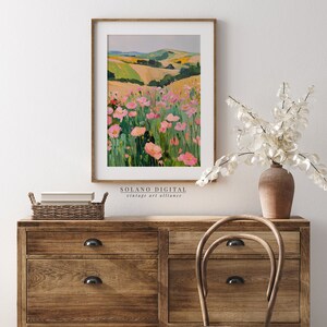 Vibrant floral landscape wall art printable featuring blooming pink flowers against rolling green hills. Perfect for adding a touch of nature and color to any space. Available on Etsy for easy download and print.