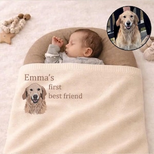 May include: A beige baby blanket with the embroidered text "Emma's first best friend" and a golden retriever graphic. A baby is sleeping in a beige nest. A circular image of a golden retriever is in the upper right corner.