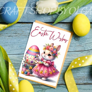 May include: A greeting card with a bunny rabbit wearing a pink dress and a flower crown, painting an Easter egg. The card has the text "Easter Wishes" in pink.