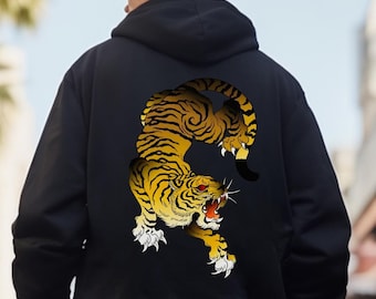 May include: Black hooded sweatshirt with a graphic print of a yellow and black tiger on the back. The tiger is in a crouching position with its mouth open and teeth showing.