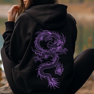 May include: Black hoodie with a purple dragon graphic on the back. The dragon is detailed and intricate, with scales and flames.