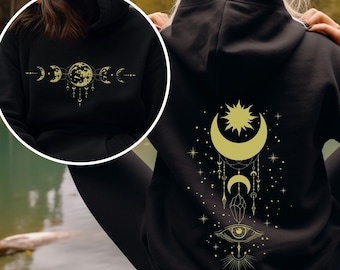 Felpa con cappuccio a tema fasi lunari celestiali, grafica con occhio onniveggente, stile mistico e magico ispirato alla luna.