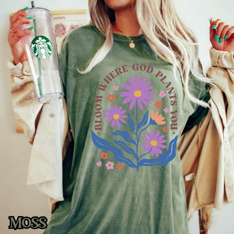 May include: Green t-shirt with a floral design and the text "Bloom where God plants you."
