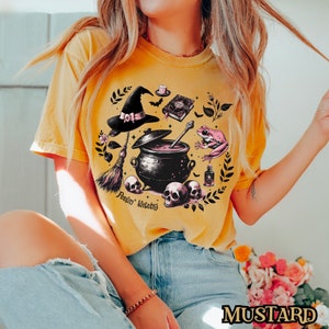 Mystical Witchy T-Shirt, Enchanting Cauldron and Skulls Design, Witch Hat and Magic Frog, Vintage Halloween Tee, Spooky Witchcraft Style Mustard
