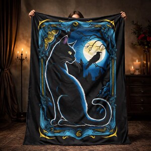 May include: Black blanket featuring a black cat with yellow eyes, a raven, and a full moon in a blue and gold frame. The cat is sitting, looking to the left. The background is a dark blue night scene.