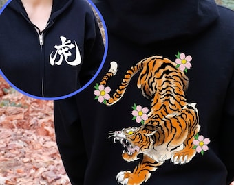 May include: Black hooded sweatshirt with a white kanji character on the front and a tiger with cherry blossoms on the back.