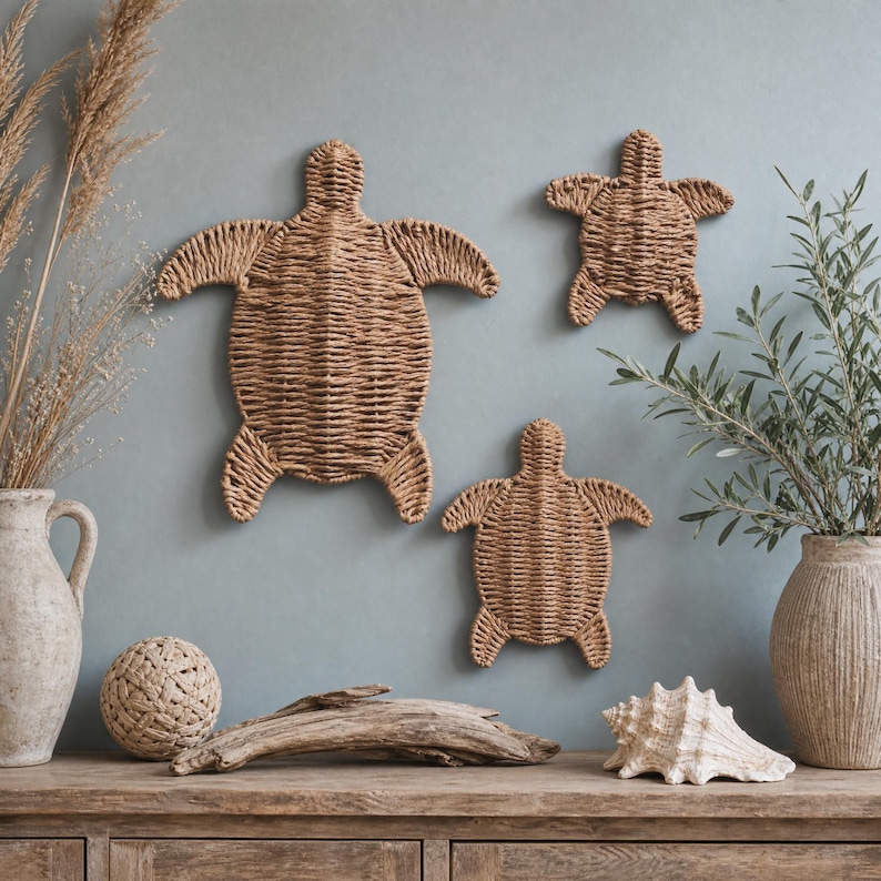 a wooden shelf with various decorative items, including three woven turtle-shaped wall hangings, a vase with greenery, a driftwood log, and a seashell.