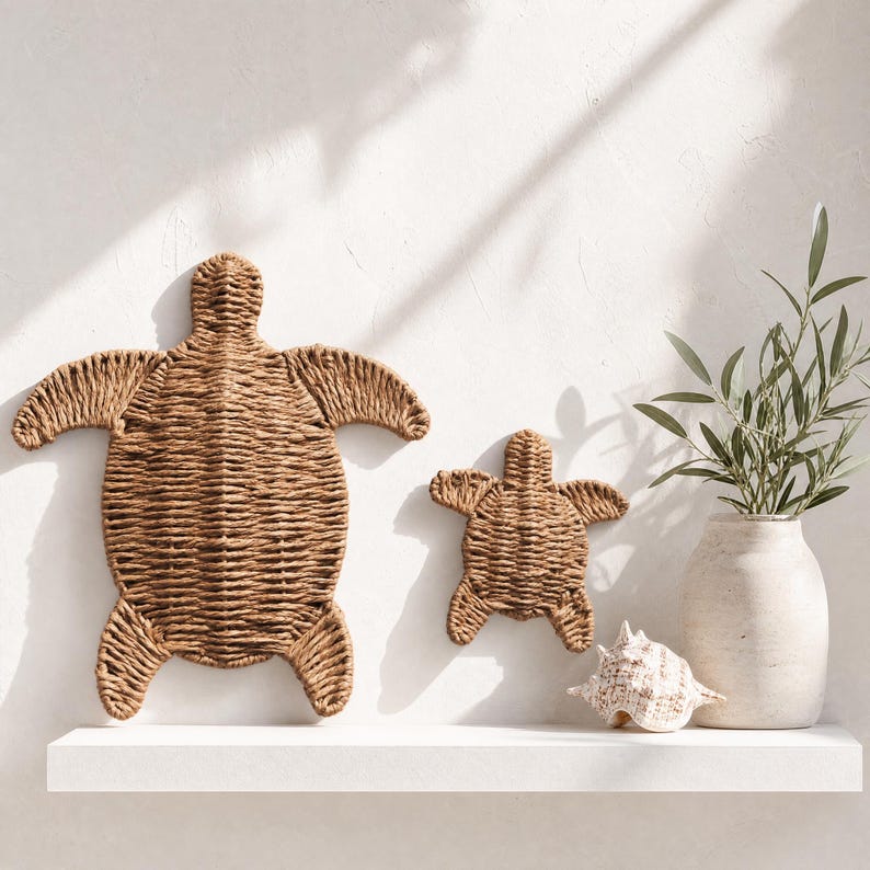 a shelf with two woven turtle-shaped wall decorations and a small white vase with a plant.