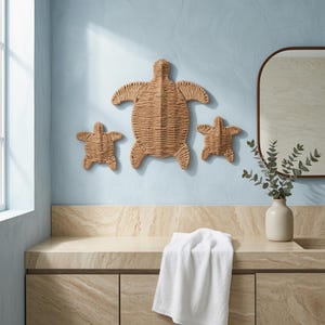 a bathroom with a blue wall, a wooden turtle decoration, a towel, and a vase with greenery.