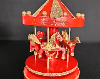 Vintage music box Jingle Bells carousel made of red painted plywood