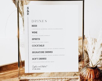 May include: A white sign with a gold frame lists the drinks available at a wedding reception. The sign reads "S&R Drinks" and lists beer, wine, spirits, cocktails, signature drinks, and soft drinks. The sign is on a table with a brown vase and a white flower arrangement.