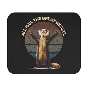 May include: A black mouse pad with a retro-style graphic of a weasel with its arms raised. The graphic is surrounded by a circle with the text "All Hail The Great Weasel".