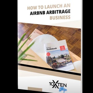 May include: A book cover with the title "HOW TO LAUNCH AN AIRBNB ARBITRAGE BUSINESS" in black and gray text. A "Guest Guidebook" from Airbnb is on a wooden surface. The book is white with a photo of a building.