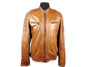 Puede incluir: Una chaqueta de cuero marrón con cierre de cremallera y varios bolsillos. La chaqueta tiene un diseño acolchado en los hombros y los codos.