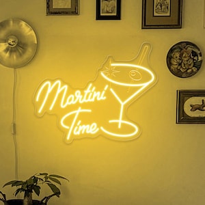May include: A neon sign with a martini glass and the text "Martini Time" in a yellow glow. The sign is mounted on a wall with a white background.