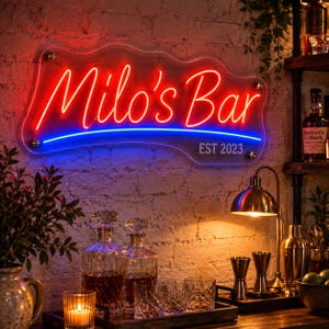 Op de afbeelding: Een op maat gemaakt neonbord aan een bakstenen muur met de rode tekst Milo's Bar boven de blauwe tekst EST 2023. Het bord is gemonteerd op een doorzichtige, golvende acrylplaat en verlicht de baropstelling die eronder is geplaatst.
