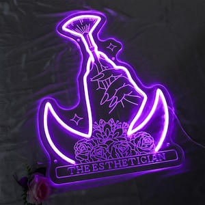 May include: A purple neon sign with a beauty theme. The sign features a hand holding a makeup brush, roses, and the text "THE ESTHETICIAN". The sign is illuminated with a bright purple glow.
