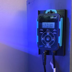 May include: Two black Jecod control units mounted on a wall. The top unit displays "F030" on a digital screen. The bottom unit, labeled "D-Series Vario Wave Maker," has a Bluetooth symbol and control buttons.