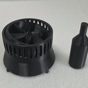 May include: A set of three ceramic mugs with a speckled, matte finish in cream, light grey, and dark grey. Each mug has a simple, minimalist design, suitable for coffee or tea.