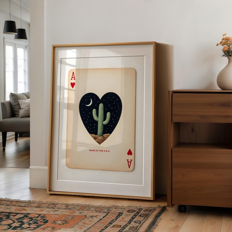 May include: Framed art print featuring an Ace of Hearts playing card design. The card showcases a heart-shaped image of a cactus under a starry night sky. The text "MADE IN THE U.S.A." is printed at the bottom of the card.