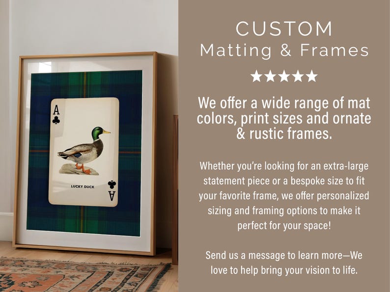 May include: Framed artwork featuring a playing card with a duck illustration, set against a blue and green plaid background. The frame is a light wood color. The text "CUSTOM Matting & Frames" is at the top.