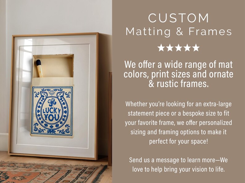 May include: Framed artwork featuring a matchbox design with a blue horseshoe and the text "LUCKY YOU." The artwork is set in a white mat and a light wood frame. The image also includes the text "CUSTOM Matting & Frames."