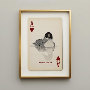 Vintage Rebel Loon art print featuring a black-and-cream common loon illustrated as the ace of hearts on an aged playing card, displayed in a slim gallery gold frame.